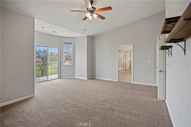 a view of a livingroom with a ceiling fan and window