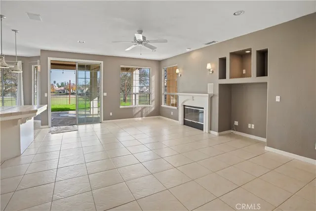 a view of an empty room with a fireplace and a window