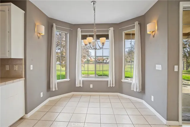 a view of an entryway and an empty room and windows