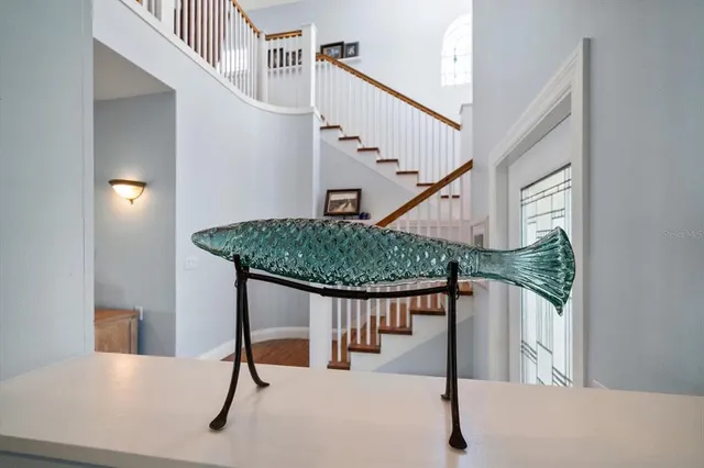 a kitchen with stainless steel appliances a refrigerator a sink a stove a table and chairs