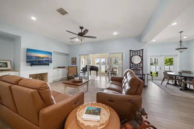 a living room with furniture and a floor to ceiling window