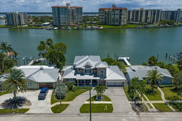 an aerial view of a house with outdoor space and lake view