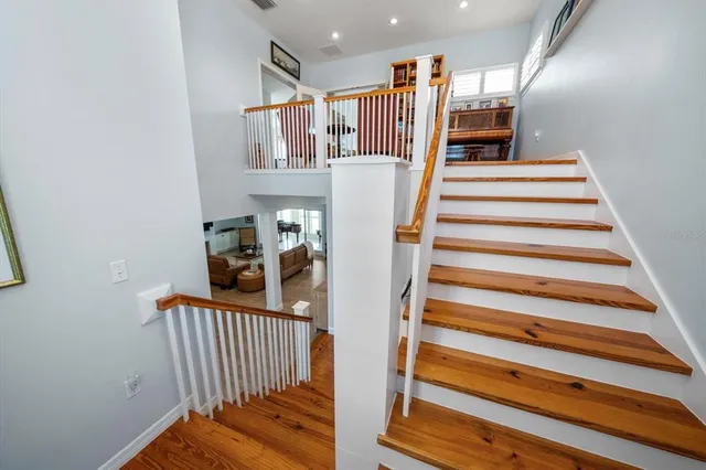 a front view of a house with a garden and trees