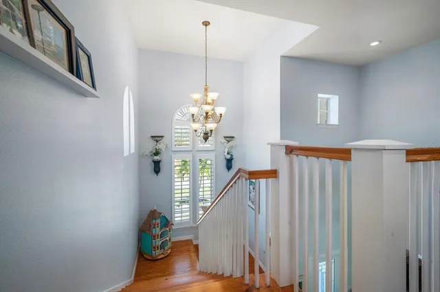 a view of a patio with couches chairs under an umbrella