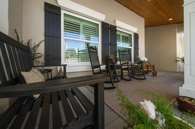 a living room with furniture a ceiling fan and a flat screen tv