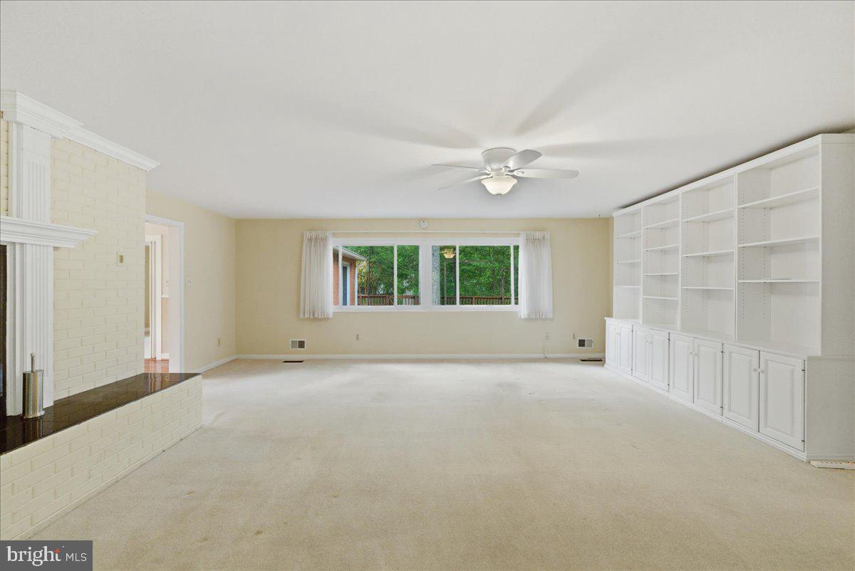 18309 Cabin Road Triangle, VA 22172 - Photo 7 of 42 an empty room with windows and chandelier fan