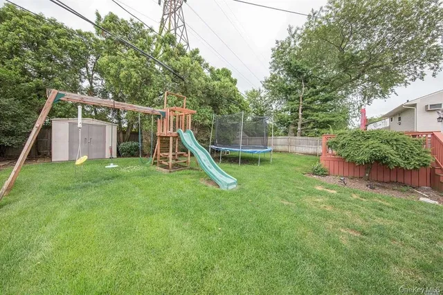 a view of a house with a backyard and a slide