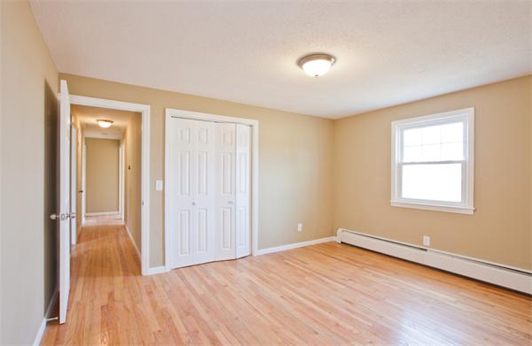 140 Druid Hill Road Springfield, MA 01129 - Photo 13 of 23 an empty room with wooden floor and windows