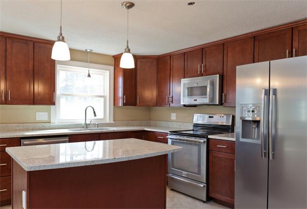 140 Druid Hill Road Springfield, MA 01129 - Photo 4 of 23 a kitchen with stainless steel appliances granite countertop a sink a microwave a refrigerator and wooden cabinets