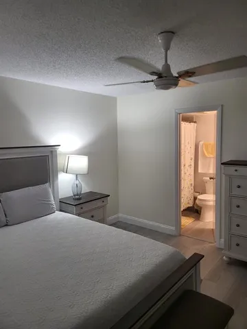 a bedroom with a bed and a lamp