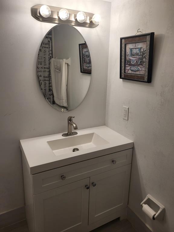 8305 Northwest 61st Street, Unit C110 Tamarac, FL 33321 - Photo 12 of 15 a bathroom with a sink and a mirror