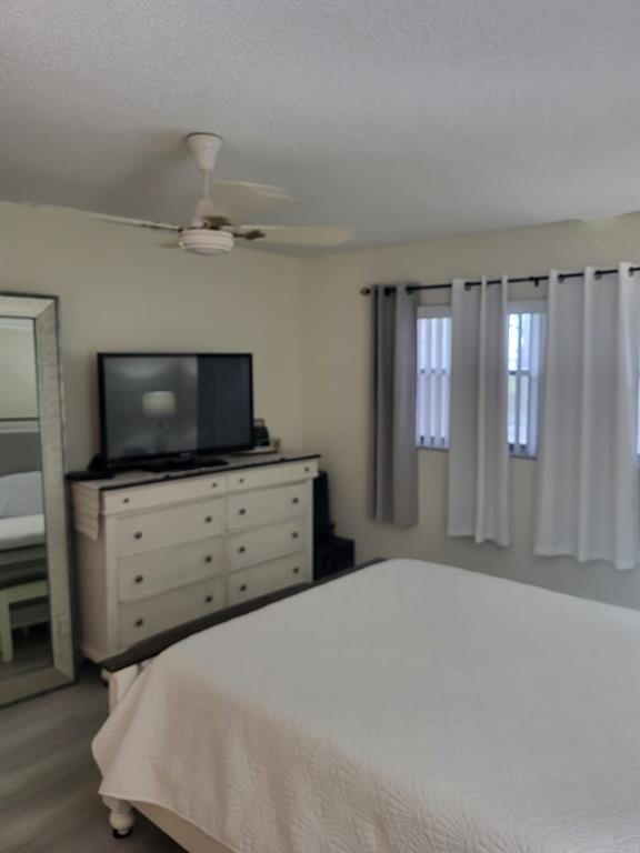 8305 Northwest 61st Street, Unit C110 Tamarac, FL 33321 - Photo 13 of 15 a bedroom with a bed and flat screen tv