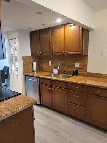 a kitchen with sink and cabinets