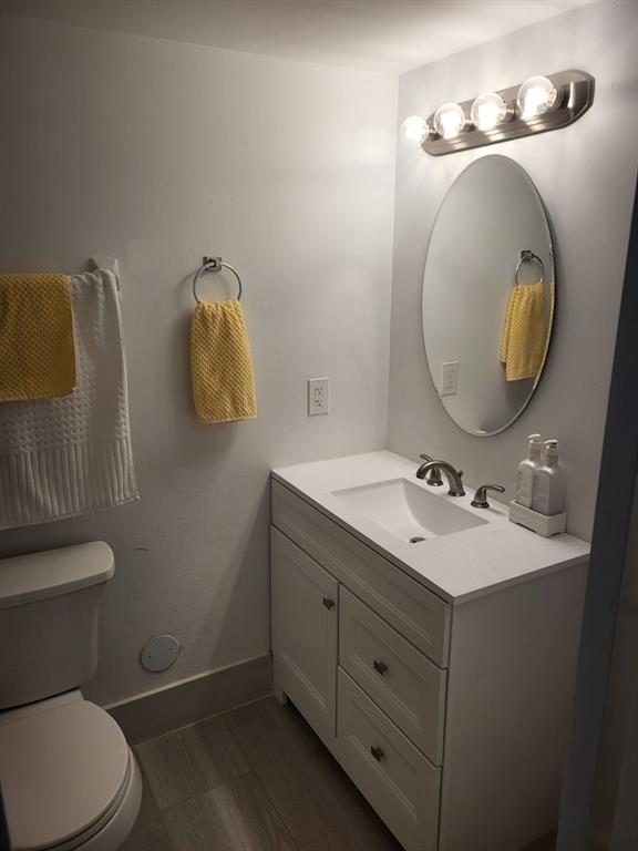 8305 Northwest 61st Street, Unit C110 Tamarac, FL 33321 - Photo 8 of 15 a bathroom with a toilet sink and mirror