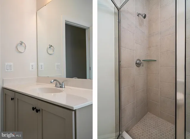 a bathroom with a shower sink and mirror
