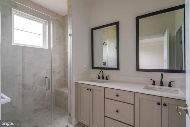 a bathroom with double sink and a mirror