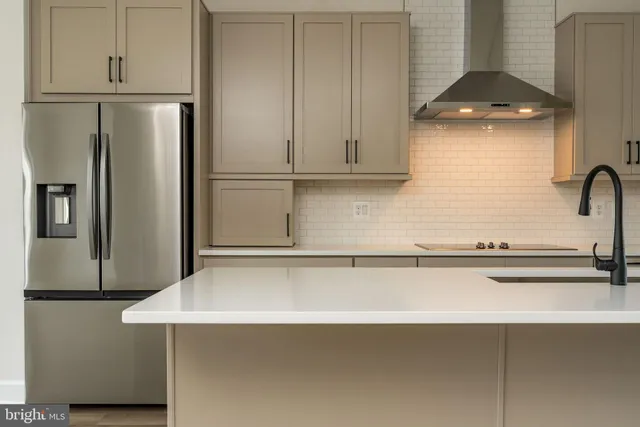 a kitchen with a refrigerator and cabinets