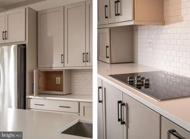 a kitchen with white cabinets and black appliances