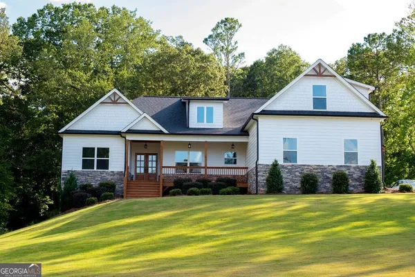 a front view of a house with a garden