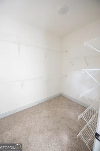 an empty room with windows and ceiling fan