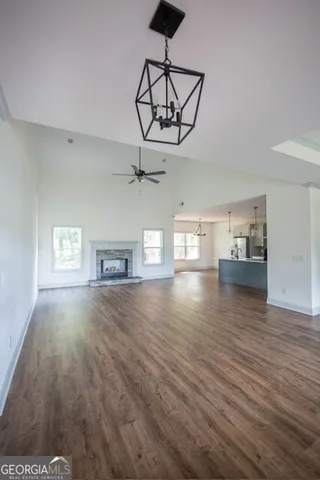 a view of empty room with wooden floor and window
