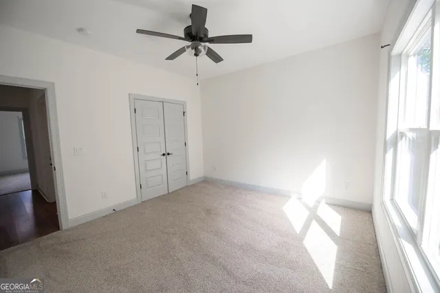 a view of an empty room and a window