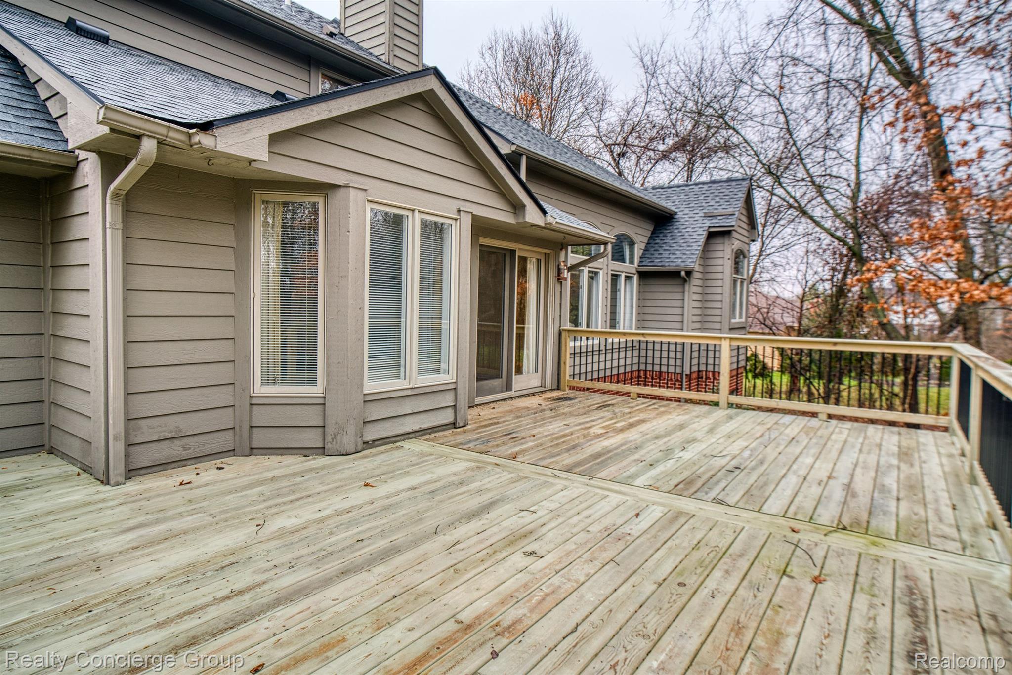 9514 Quail Ridge Run Brighton, MI 48114 - Photo 35 of 37 Newer deck, so much space for seating/entertaining