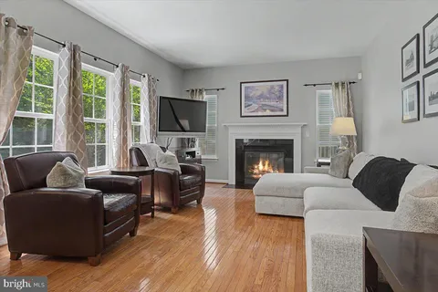 a living room with furniture flat screen tv and a fireplace