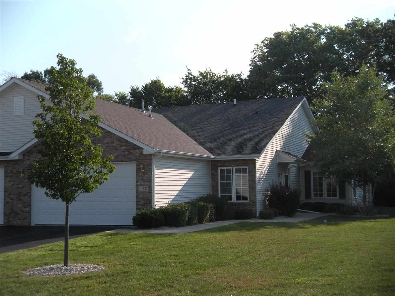 10337 Marblewing Road Roscoe, IL 61073 - Photo 1 of 14 a house that has a tree in front of it