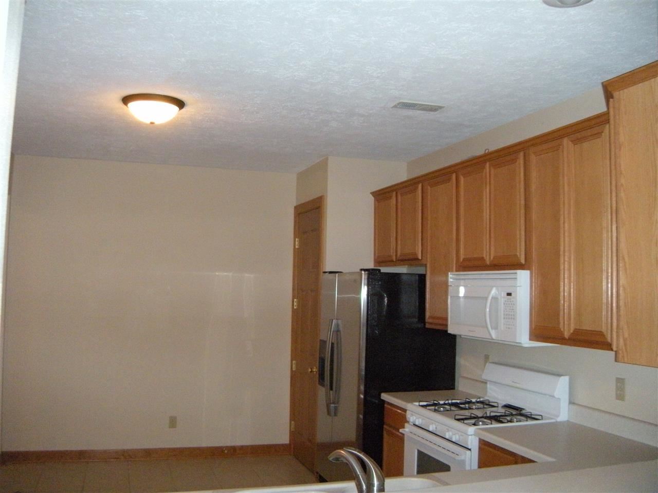 10337 Marblewing Road Roscoe, IL 61073 - Photo 14 of 14 a kitchen with stainless steel appliances a refrigerator a stove a sink and a stove