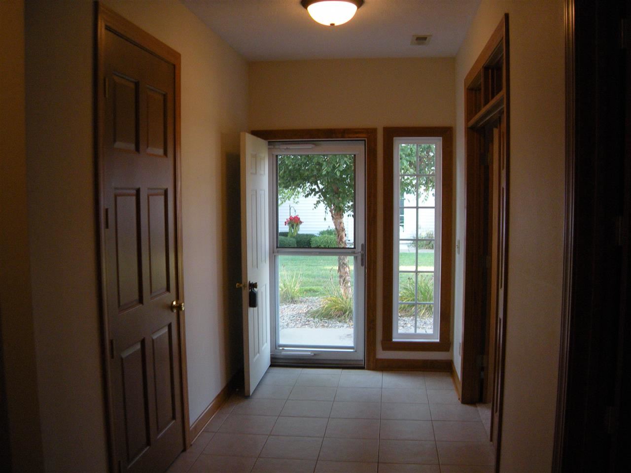 10337 Marblewing Road Roscoe, IL 61073 - Photo 8 of 14 a view of hallway with a large window and front door