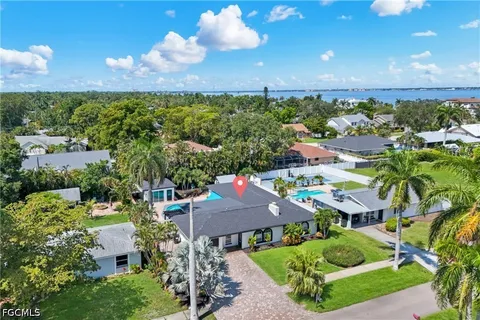 an aerial view of residential houses with outdoor space and street view