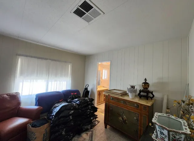 a bedroom with a bed and a large mirror