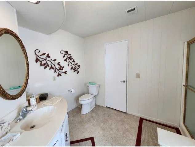 a hallway with wooden floor and furniture