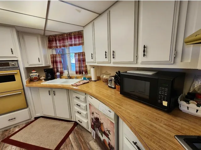 a kitchen with a sink a cabinets and appliances