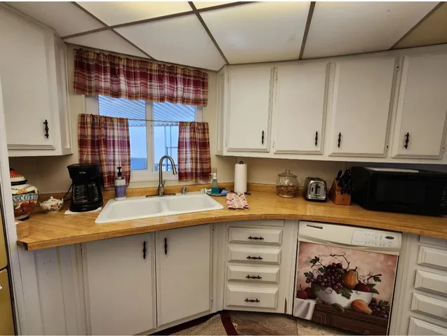 a view of kitchen with furniture and cabinets