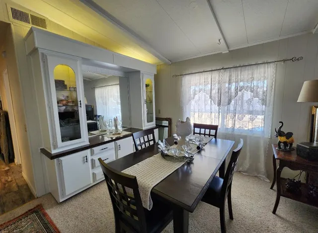 a bathroom with a granite countertop sink a mirror and next to a window