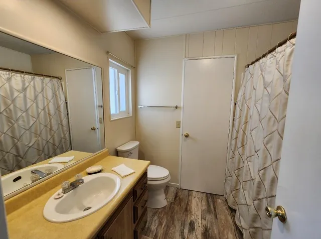 a living room with furniture a window and a lamp