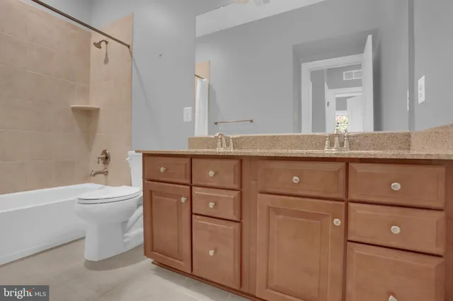 a view of entryway and kitchen with wooden floor