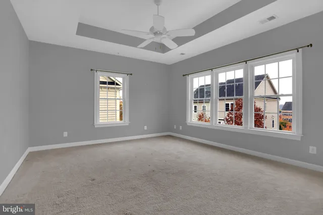 an empty room with furniture and windows