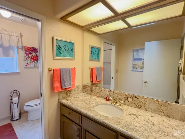 a white toilet sitting next to a shower curtain