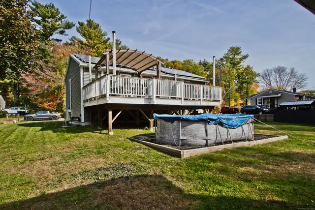 a view of a house with pool and sitting area