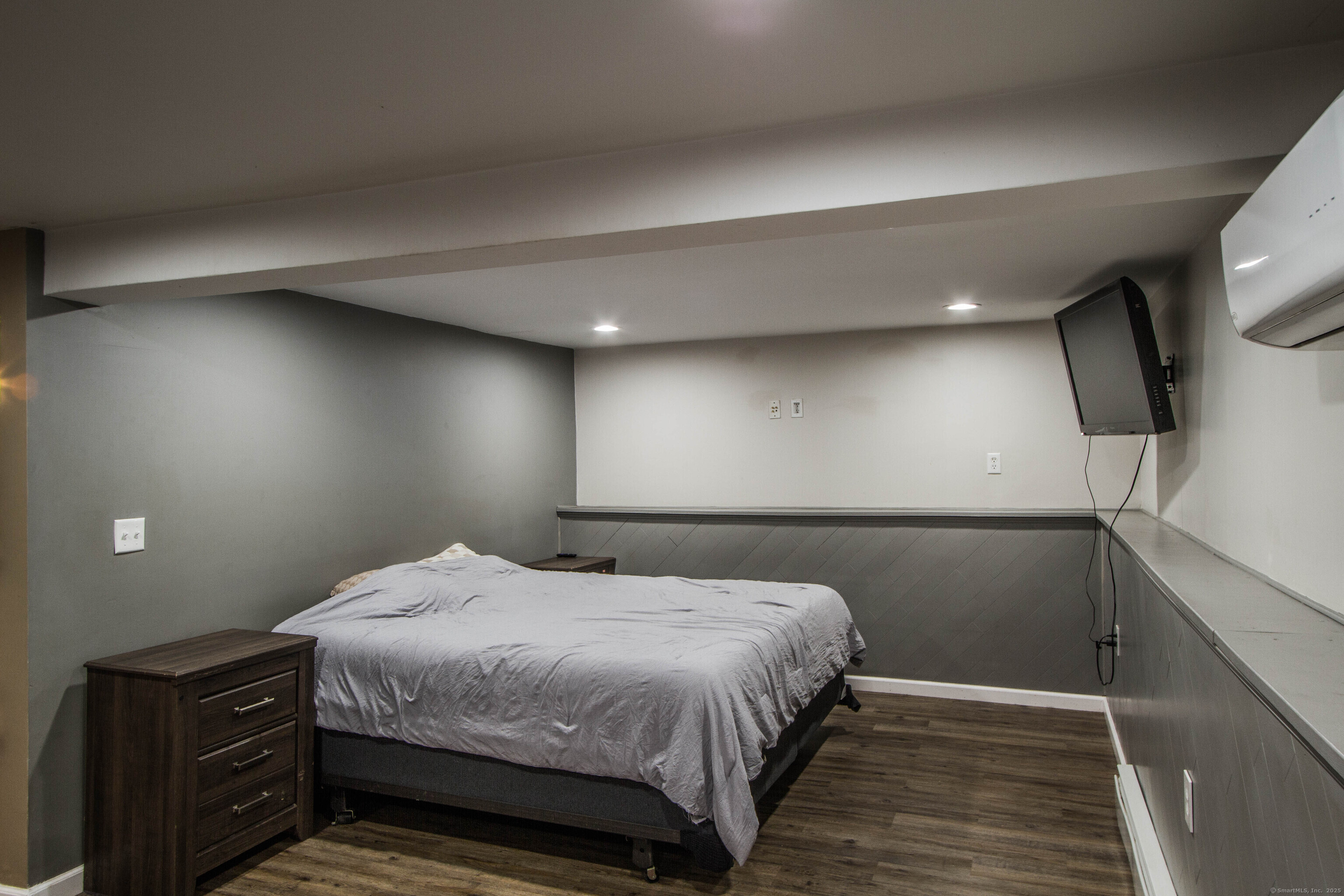 24 David Circle Putnam, CT 06260 - Photo 36 of 39 a bedroom with a bed and a flat tv screen on dresser