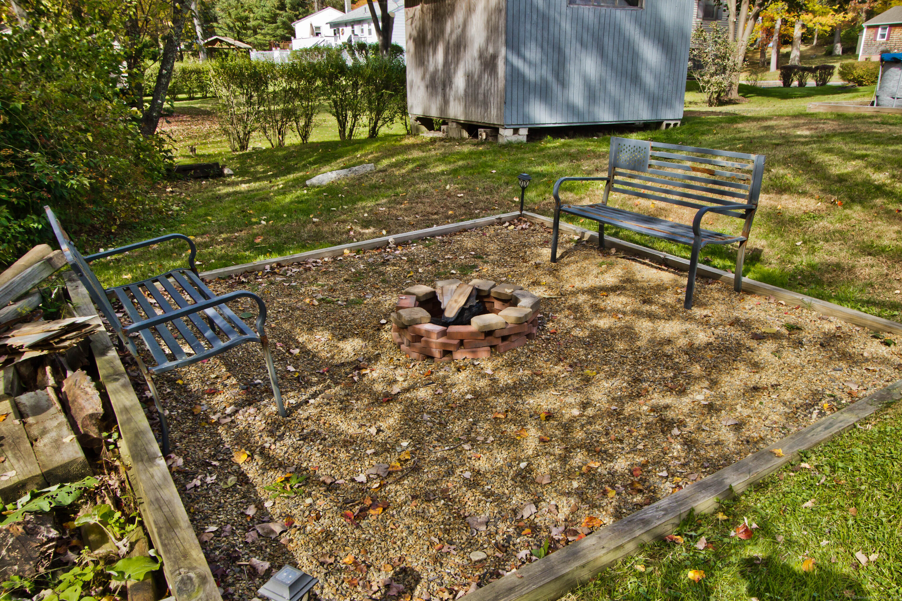 24 David Circle Putnam, CT 06260 - Photo 8 of 39 a bench sitting in the middle of a yard