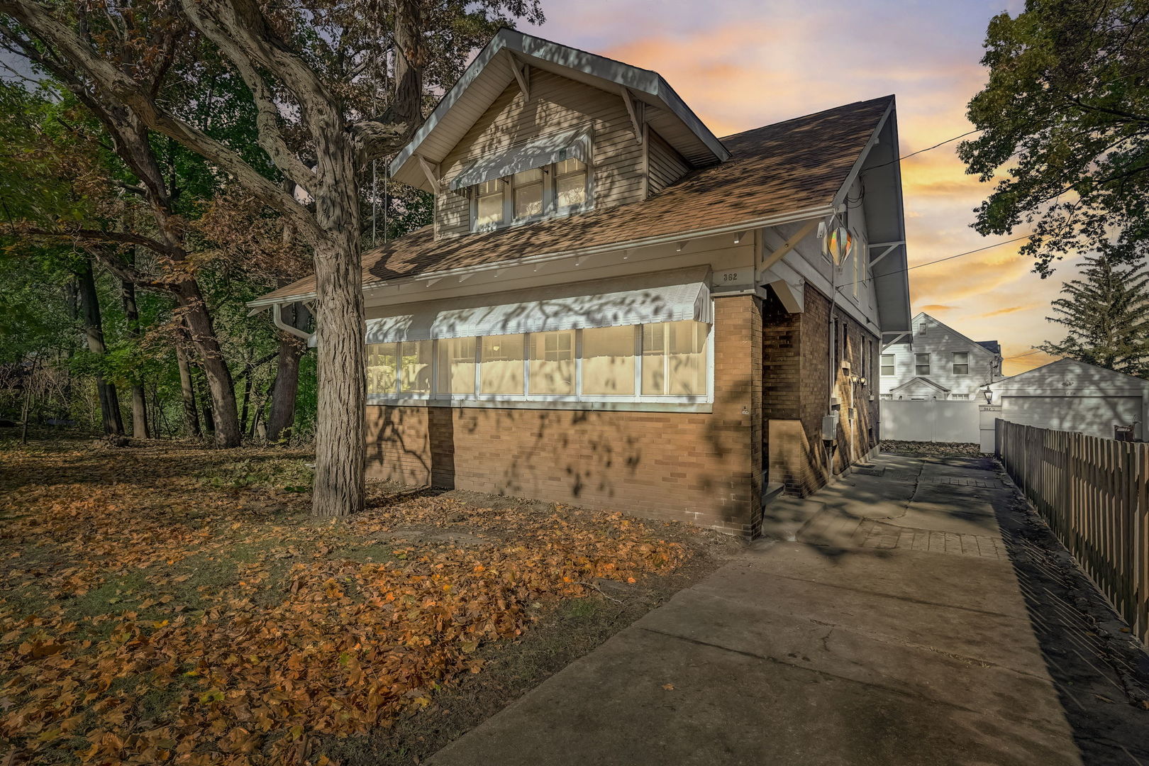 a view of a house with a large tree