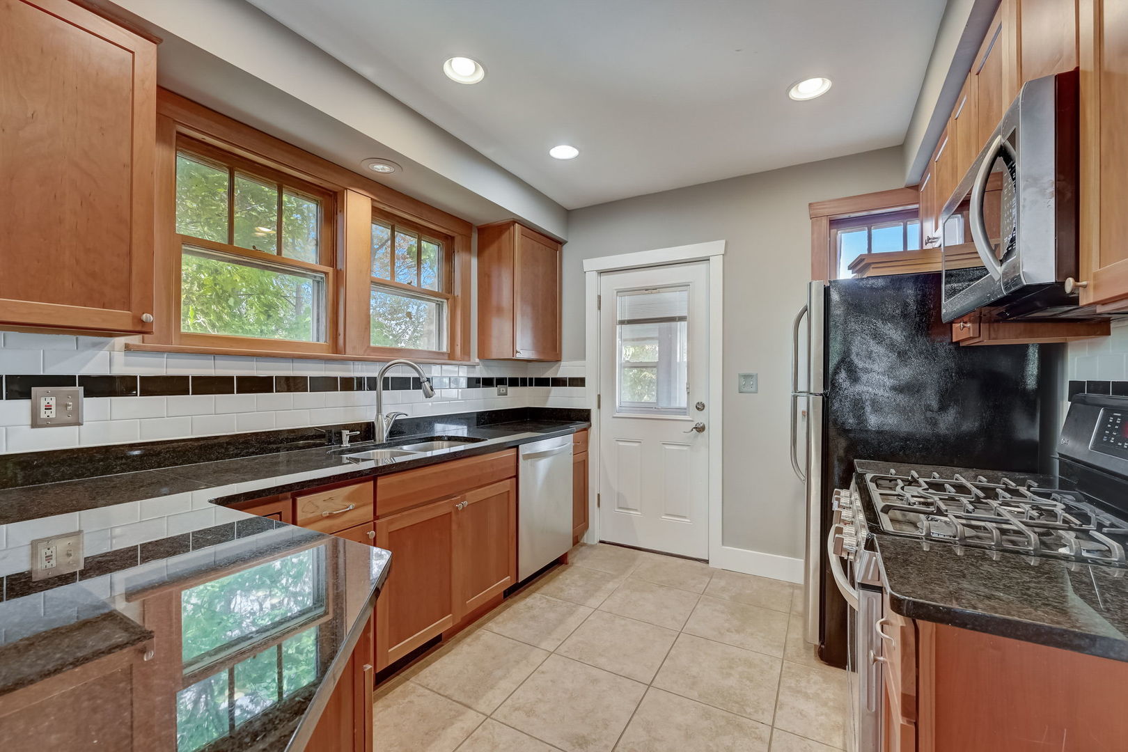 362 River Bluff Road Elgin, IL 60120 - Photo 19 of 57 a kitchen with stainless steel appliances granite countertop a stove and a sink