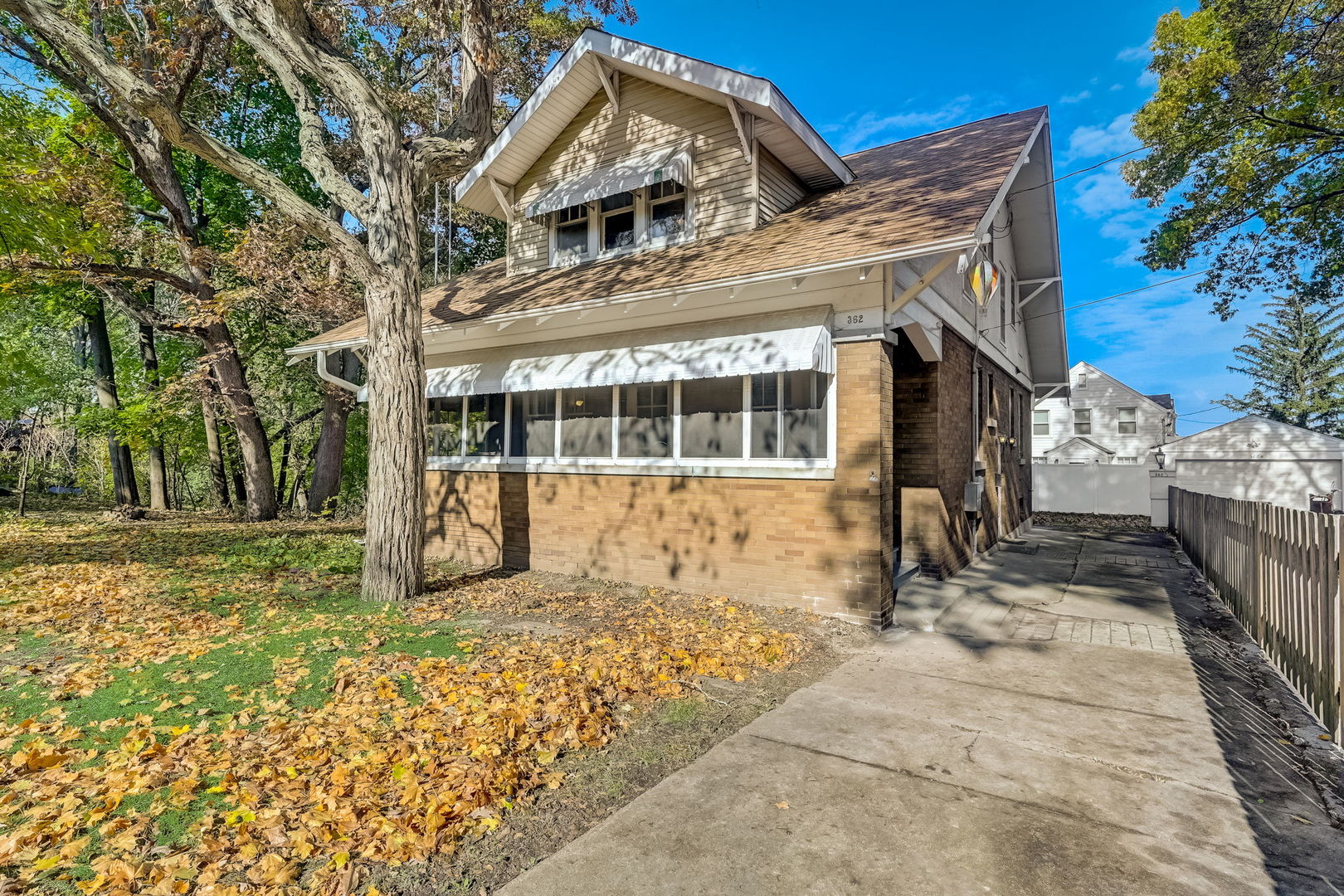 362 River Bluff Road Elgin, IL 60120 - Photo 7 of 57 a view of a white house with a large tree and wooden fence