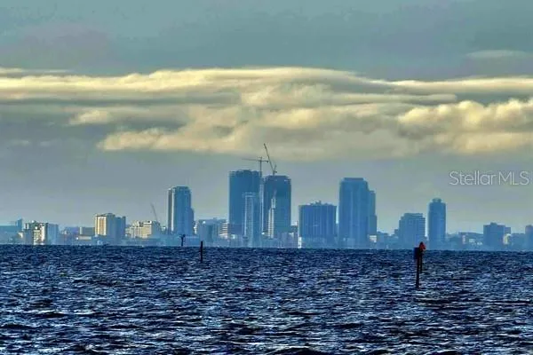a bedroom with a bed a flat screen tv and a window