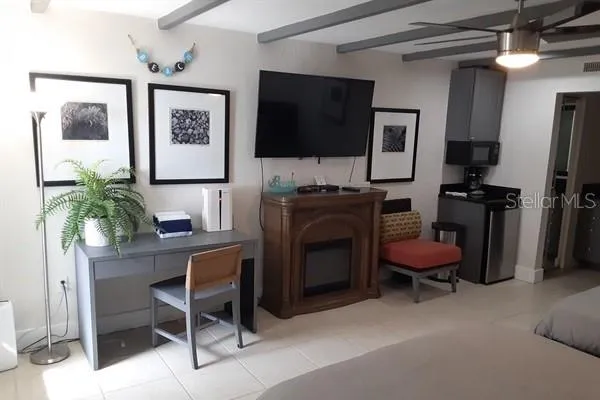 a living room with furniture a flat screen tv and a fireplace