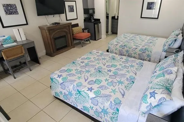 a bedroom with a bed and flat screen tv